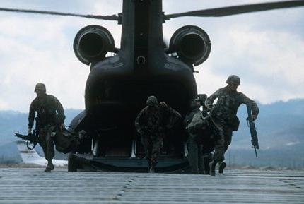 Military men stepping out of a helicopter